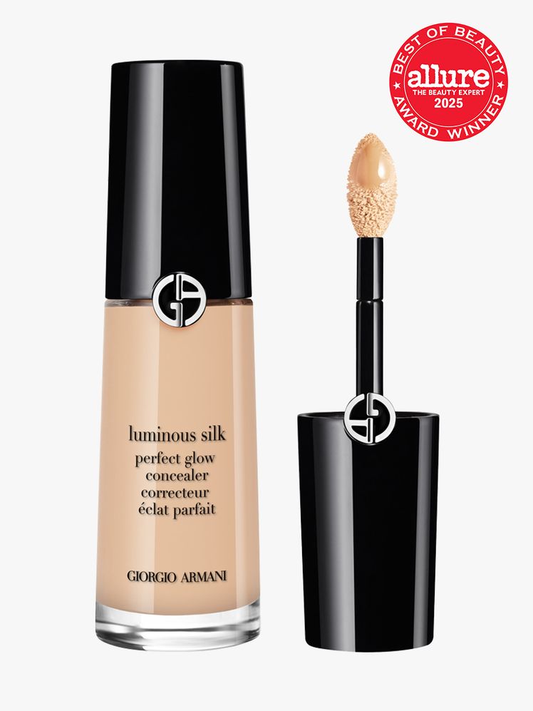 Armani Luminous Silk Concealer in branded glass bottle with black cap and doe foot applicator on light gray background...