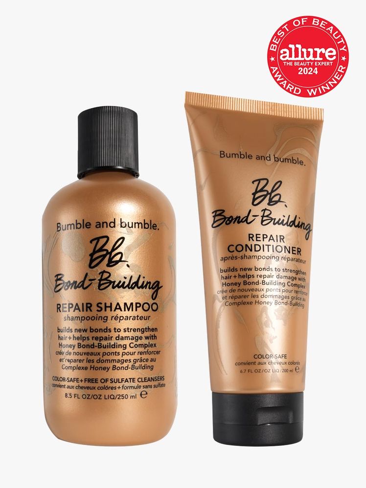 shampoo and conditioner duo in branded copper components with black caps on light gray background with red and white...