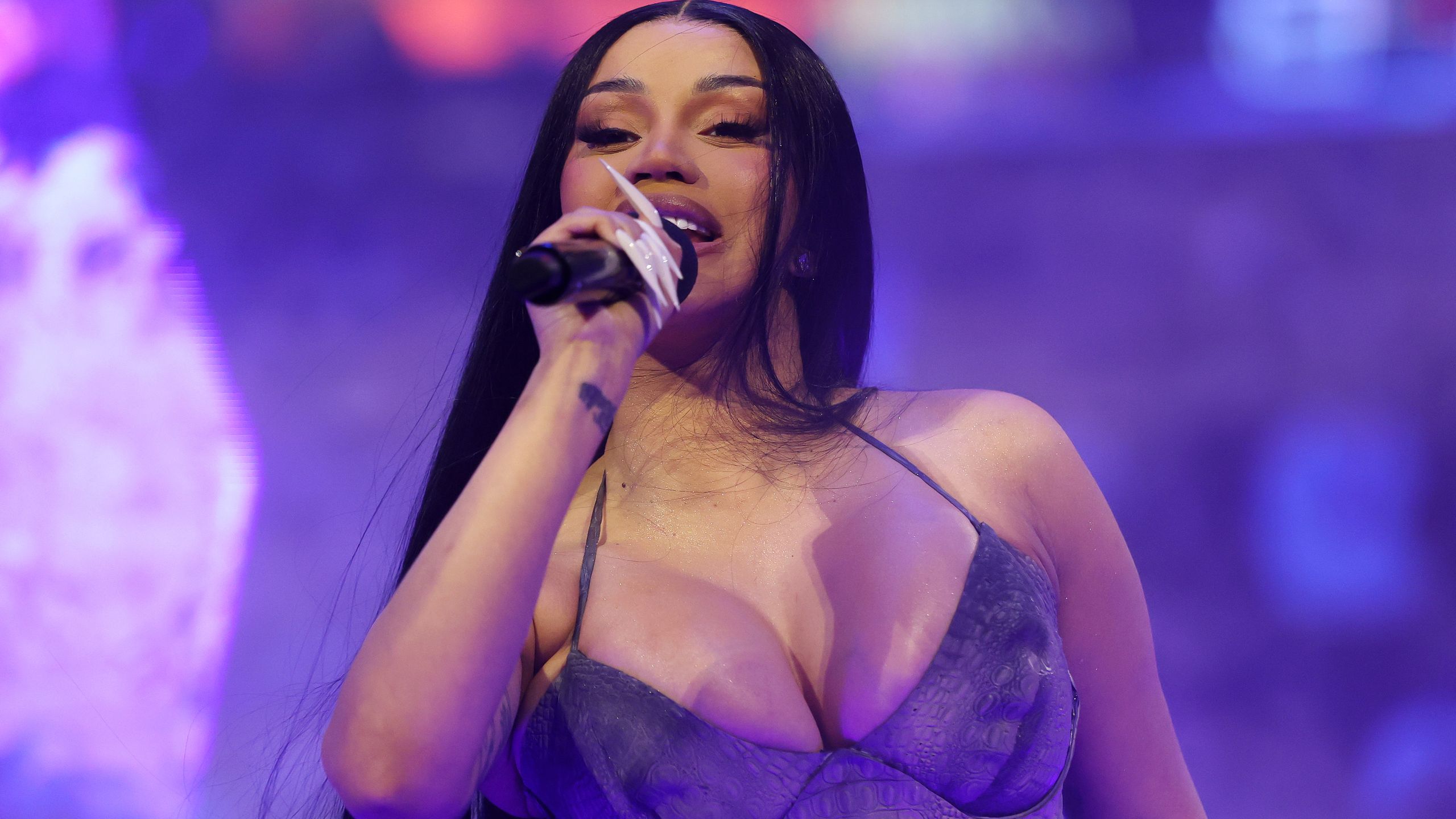 Cardi B performs at the NBA Finals game in a catsuit and long flowing hair.