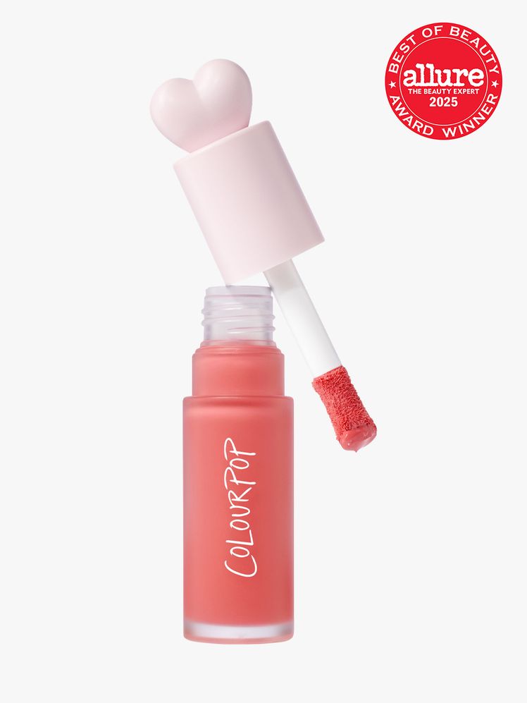 ColourPop Liquid Blush in branded clear bottle with decorative heart doe foot applicator cap on light gray background...