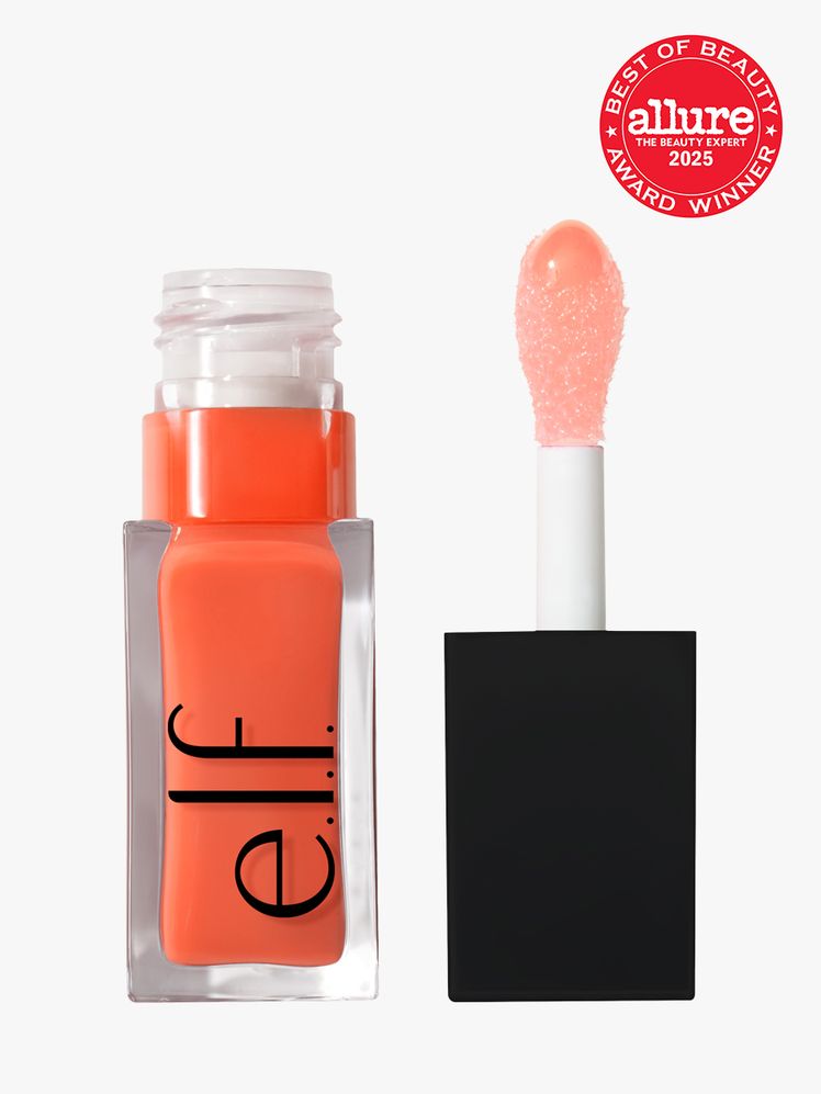 e.l.f. Cosmetics Glow Reviver Lip Oil in branded clear glass bottle with black cap with doe foot applicator on light...