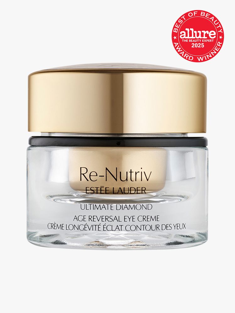 Este Lauder ReNutriv Ultimate Diamond Age Reversal Eye Creme in branded clear jar with gold twist cap on light gray...
