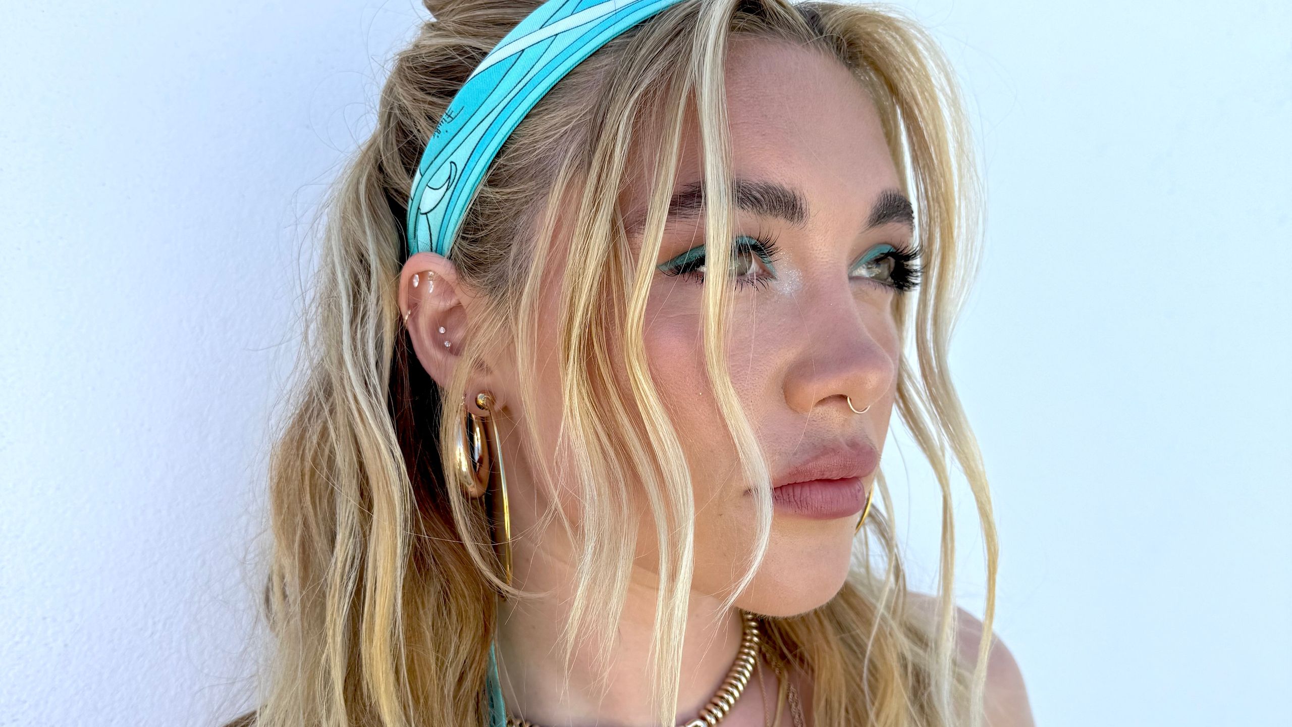 Florence Pugh posing in a blue Pucci headscarf