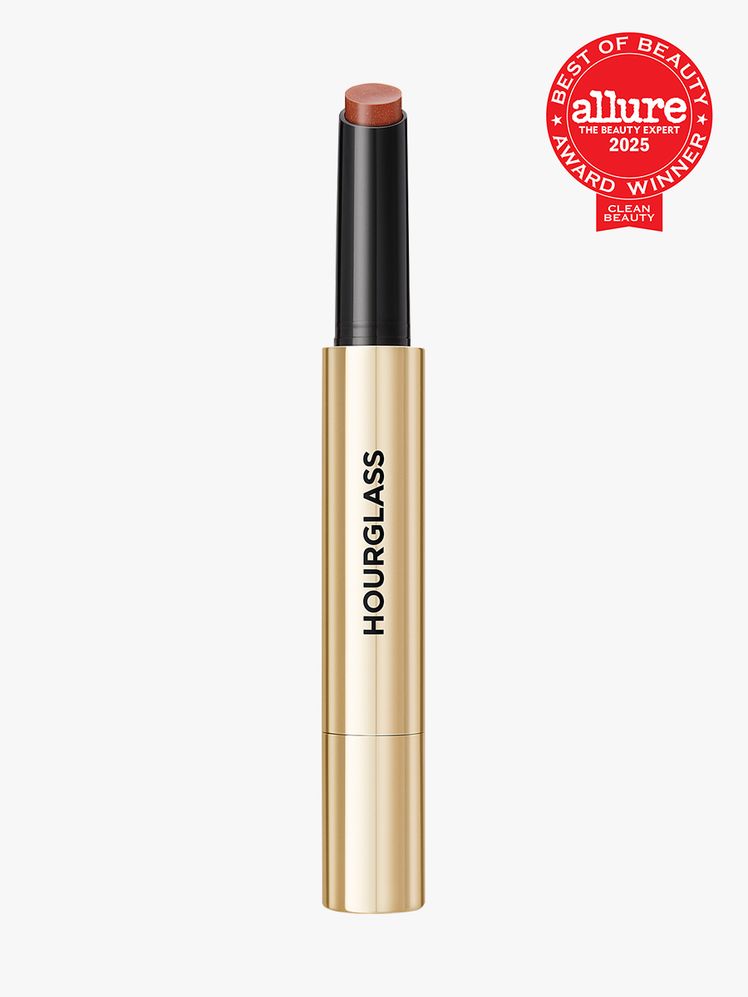 Hourglass Phantom Volumizing Glossy Balm in branded gold and black twist up applicator on light gray background with red...