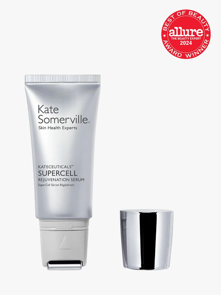 facial serum in branded silver bottle with applicator tip next to silver cap on light gray background with red and white...