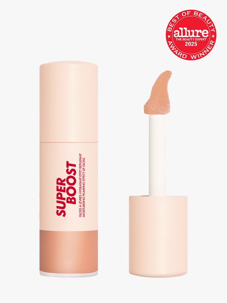 Make Up For Ever Super Boost Lip Gloss in branded peach tube with cap with attached doe foot applicator on light gray...