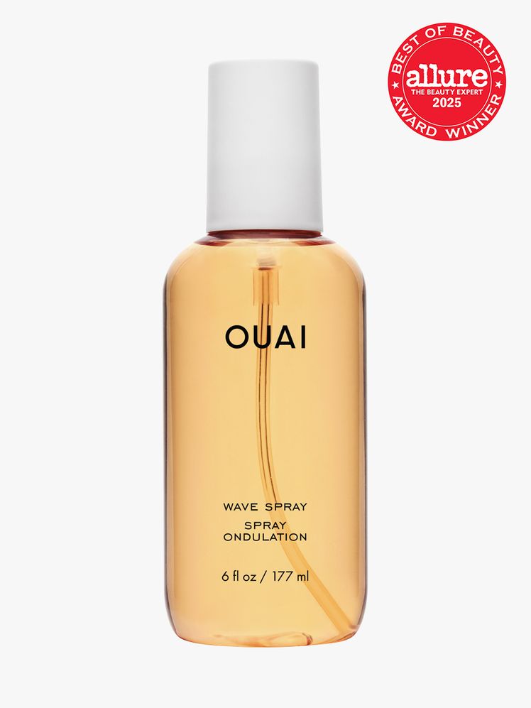OUAI Wave Spray in branded orange bottle with white cap on light gray background with red Allure Best of Beauty seal in...