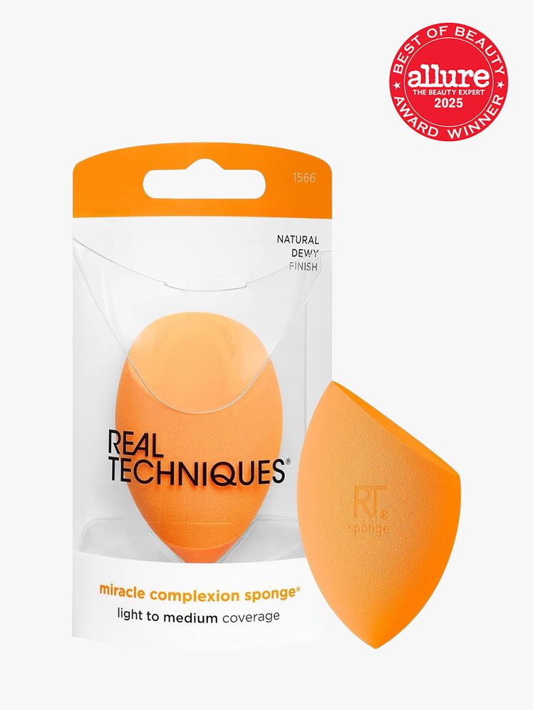 Real Techniques Miracle Complexion Sponge in branded clear packaging next to additional sponge on light gray background...
