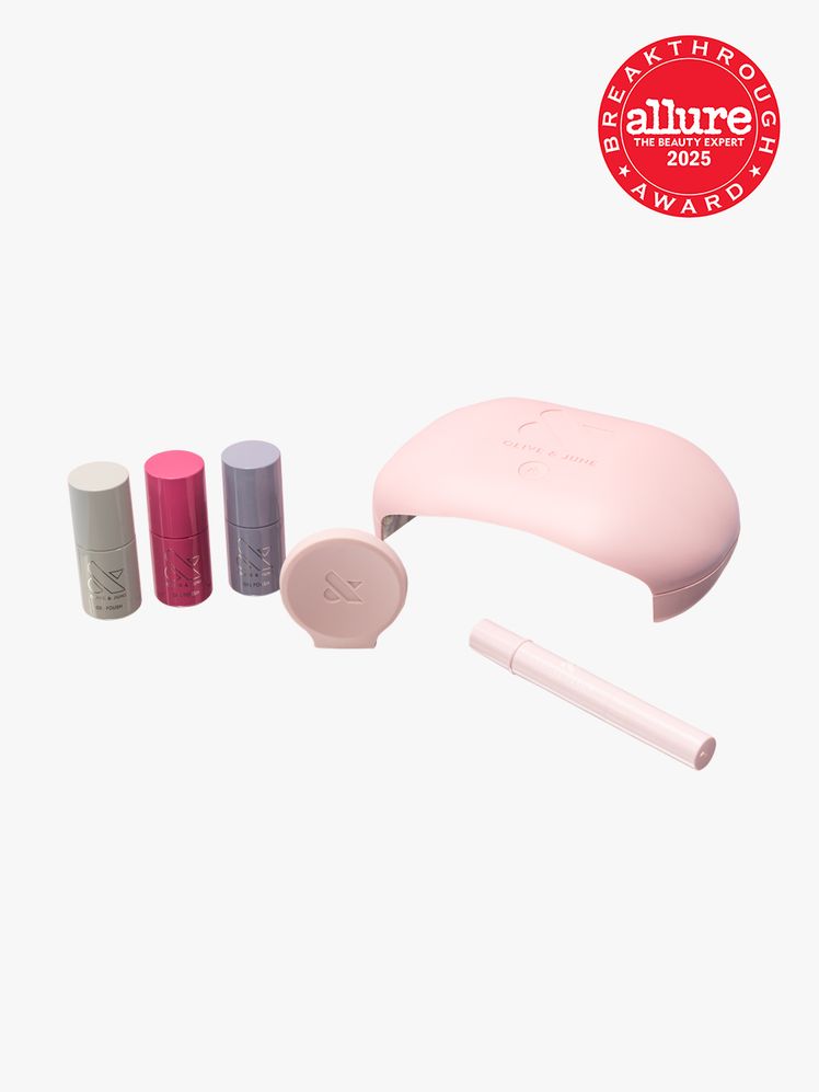 Olive  June Gel Mani System three nail polish bottles and pink gel polish dryer on light gray background with red Allure...
