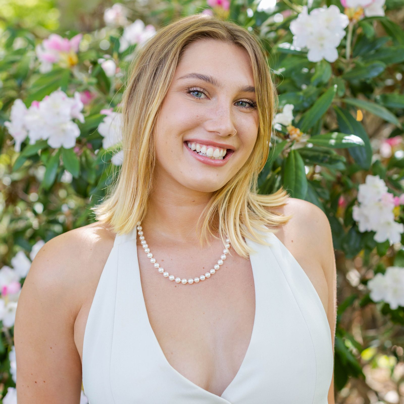 Image may contain Blonde Hair Person Accessories Jewelry Necklace Face Happy Head Smile Photography and Portrait