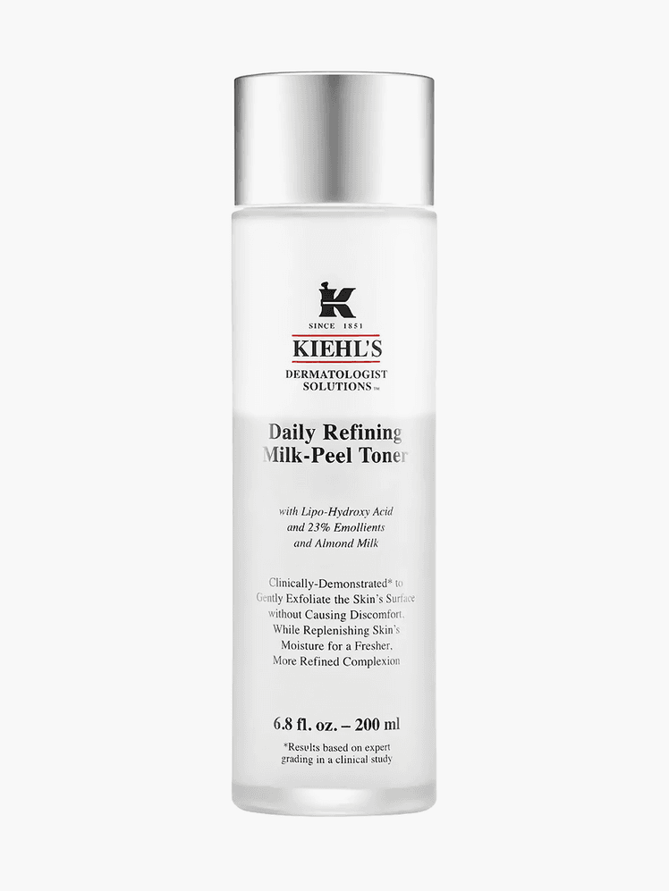 Milk-Peel Gentle Exfoliating Toner in branded clear bottle with silver cap on light gray background